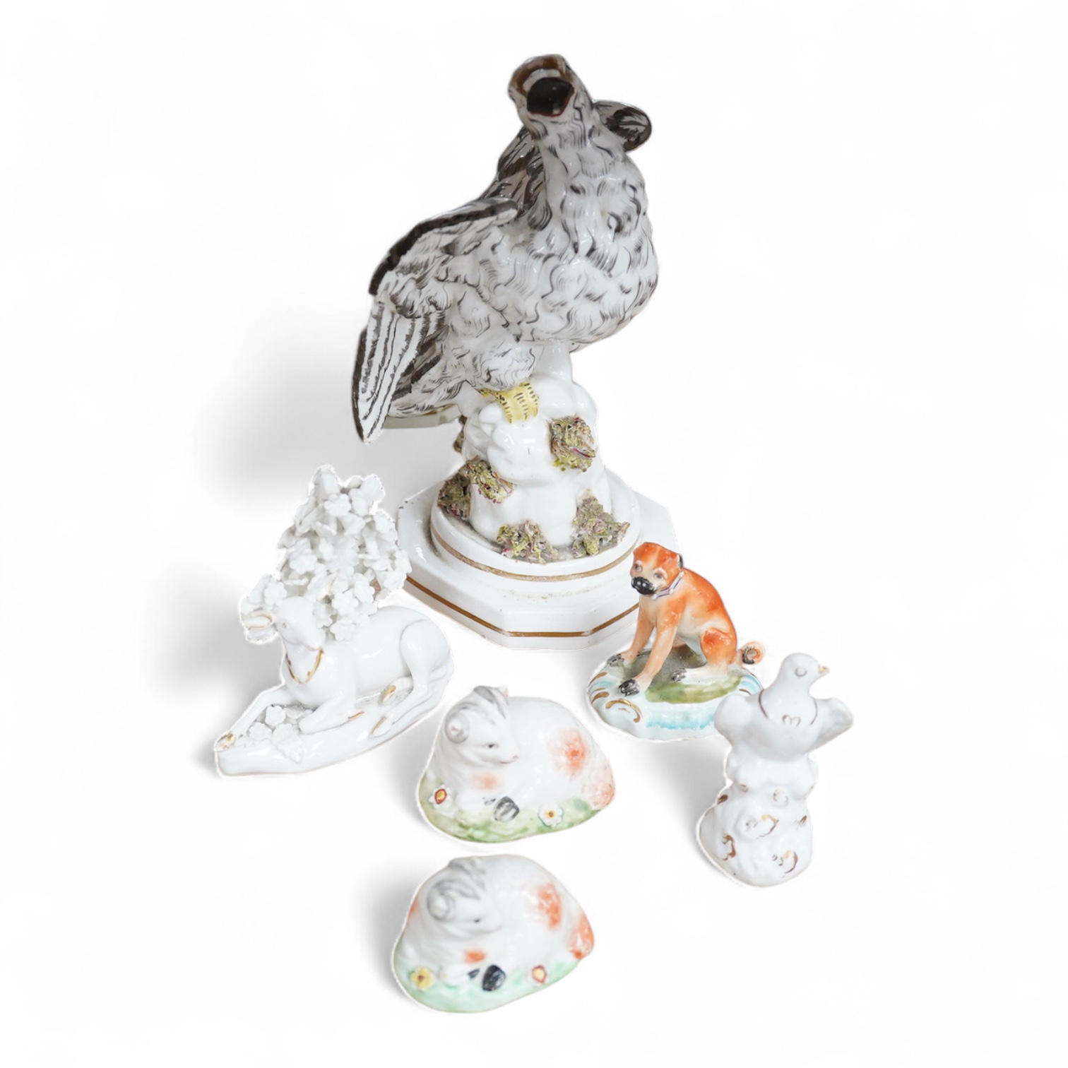 A rare Staffordshire porcelain model of an eagle or vulture, c.1830-50, and five Derby porcelain models, 1810–30; two recumbent sheep, a pug dog, a deer and a dove, 20cm high